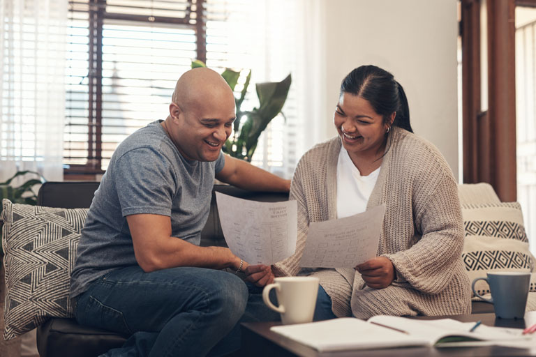Shot of a young couple going over paperwork at home.